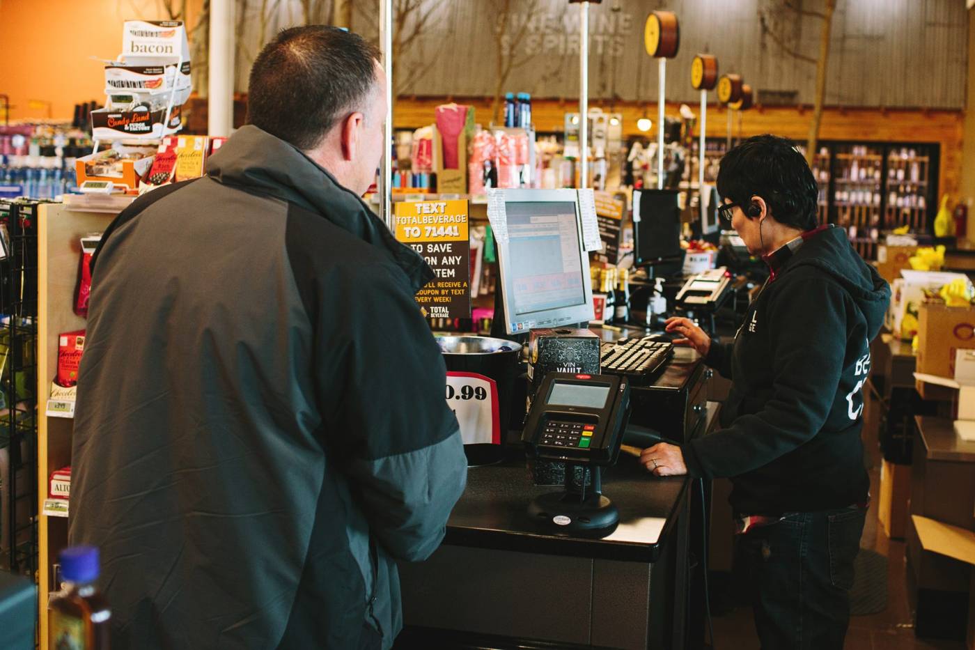 A customer checking out at the counter of a real mPower customer store